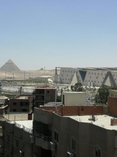 a view of a city with pyramids in the background at GEM VIEW ROOMS in Qaryat ash Shamālī