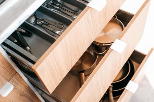 a kitchen drawer filled with pots and pans at Pivoine Camping Belle-Vue 2000 in Berdorf