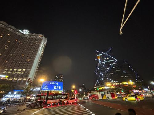 a city street at night with buildings and lights at Guangzhou City Inn Hotel Apartment Changgang in Guangzhou