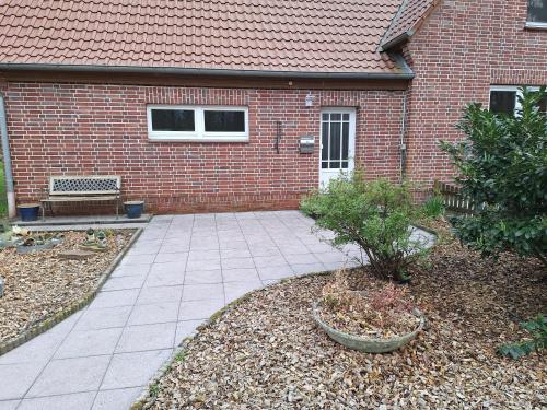 a brick house with a patio in front of it at Nebenan in Soltau