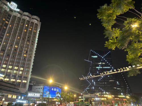 a city lit up at night with tall buildings at Guangzhou City Inn Hotel Apartment Changgang in Guangzhou