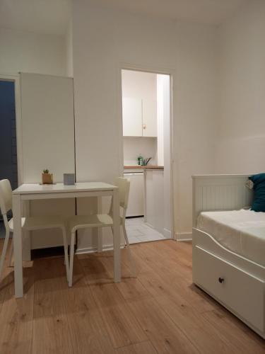 - une chambre avec une table, un lit, une table et des chaises dans l'établissement Studio bucolique, à Pont-Audemer