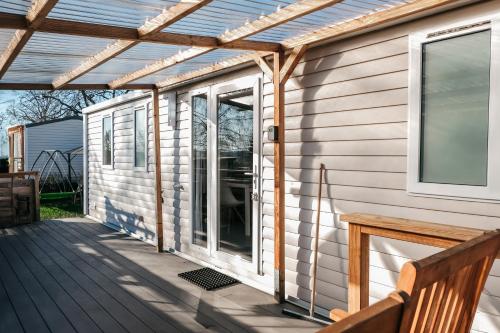 a pergola over a porch on a house at Magnolia - Camping Belle-Vue in Berdorf