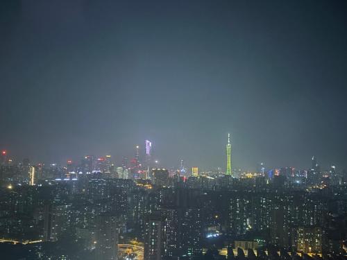 a view of a city skyline at night at Guangzhou City Inn Hotel Apartment Changgang in Guangzhou