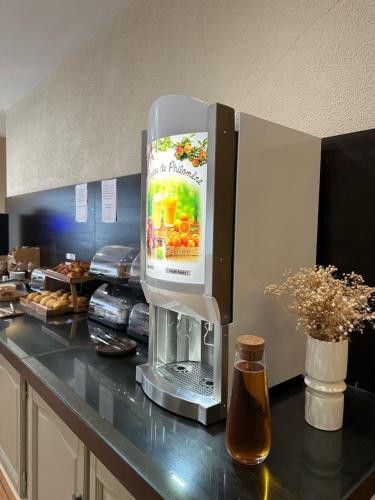 a kitchen counter with a coffee machine on it at Hôtel Thalassa in Saint-Florent