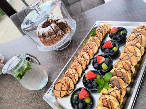a tray of pastries and fruit on a table at Grand Hotel Senica, Garni in Senica