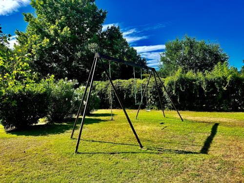 an empty swing set in a field of grass at Domaine Plan des Devens in Roussillon