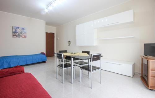 a living room with a table and chairs and a couch at Lovely Apartment In Parco Dei Tigli in Paestum