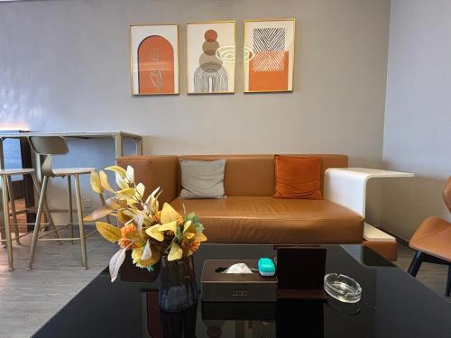 a living room with a couch and a table at Guangzhou City Inn Hotel Apartment Changgang in Guangzhou
