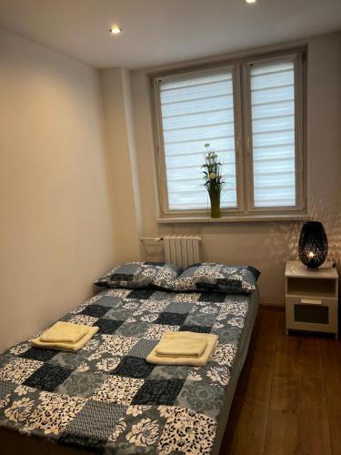 a bedroom with two beds and a window at Apartament dla Ciebie in Kętrzyn