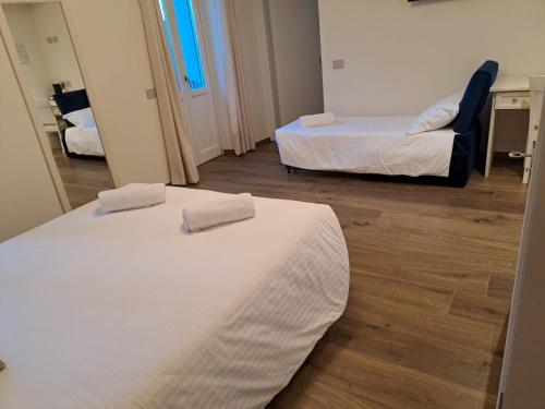 a hotel room with two beds and a chair at Villa Veronesi in San Martino della Battaglia