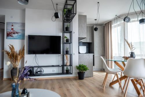 a living room with a tv and a table at Queen's Palace Balchik apartment in Balchik