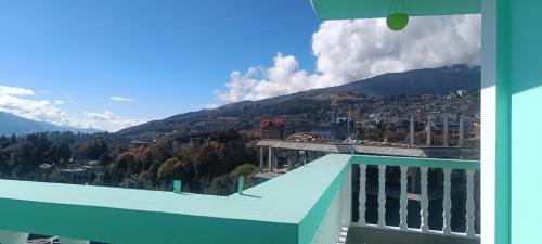 a view from the balcony of a building with a mountain at ND HOMESTAY in Tawang