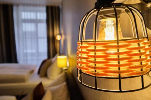 a lamp hanging on a wall in a room at Hotel Roter Hahn in Regensburg