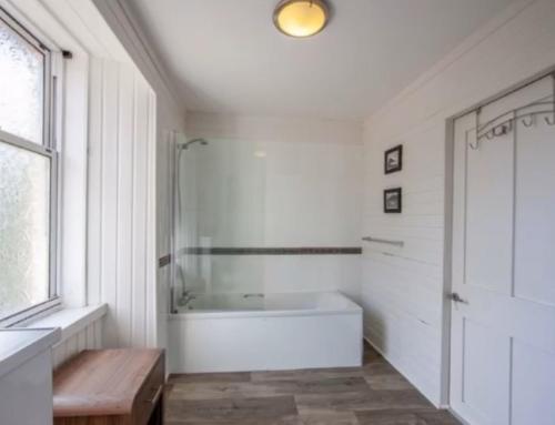 a white bathroom with a tub and a window at Room 1, Loch Etive House, Connel near Oban in Connel