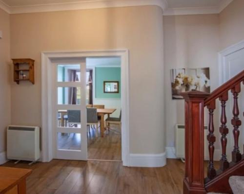 a living room with a door leading to a dining room at Room 1, Loch Etive House, Connel near Oban in Connel