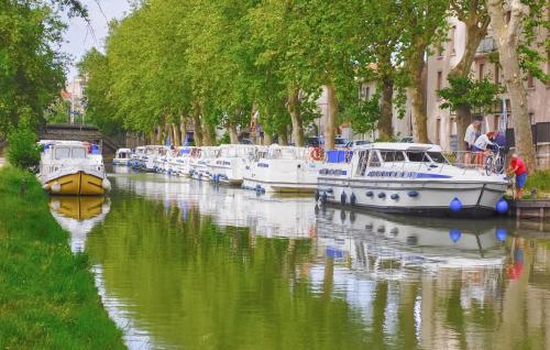 a group of boats are docked in a canal at Lovely Home In Saint-Laurent-De-La-Ca in Saint-Laurent-de-la-Cabrerisse