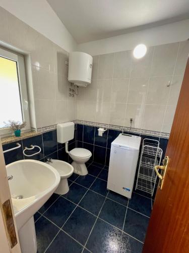 a bathroom with two toilets and a sink at Apartments Lori in Poreč