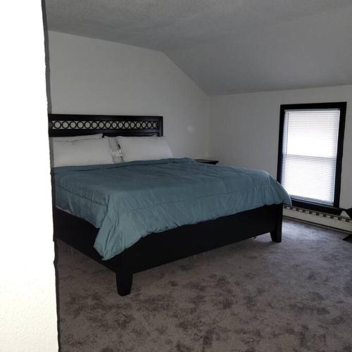 a bedroom with a bed in a white room at Entire house - 4 Bedroom-Enfield in Enfield