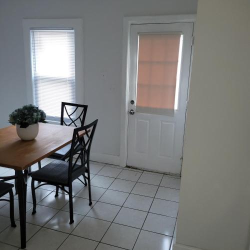 a dining room with a table and chairs and a door at Entire house - 4 Bedroom-Enfield in Enfield
