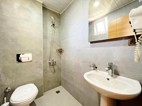 a bathroom with a sink and a toilet and a shower at Akın Apart and Hotel in Antalya