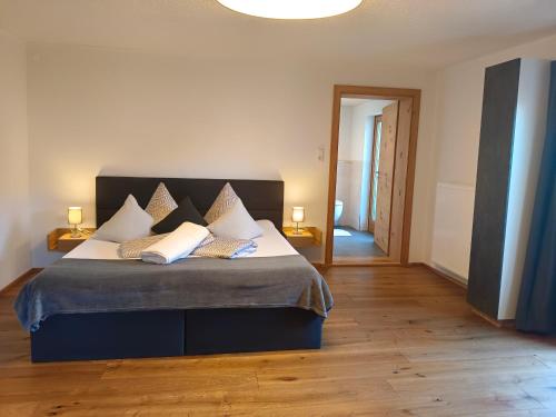 a bedroom with a large bed with two pillows at Haus Berghof in Gries am Brenner