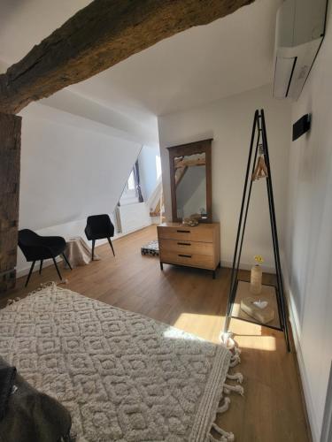 a living room with a dresser and a mirror at Domaine de charme - Les Places in Lassay-sur-Croisne