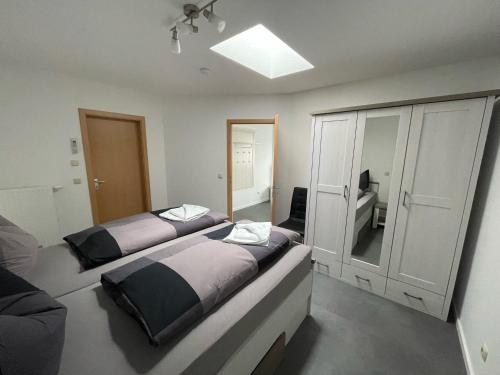 a bedroom with two beds and a mirror at Ferienhaus Pank in Heringsdorf