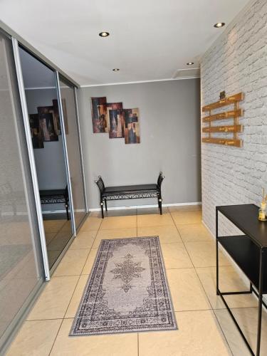 a living room with a bench and a rug at Montana Guest House. in Lillestrøm