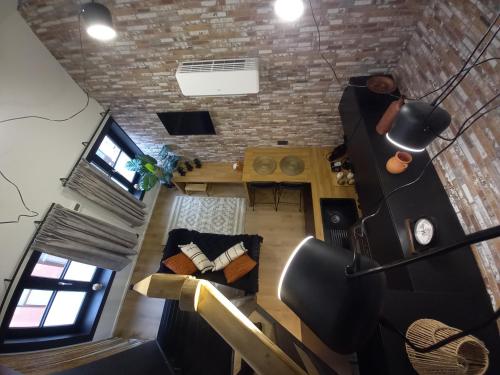 an overhead view of a living room with a brick wall at Le Pèlerin in Mons