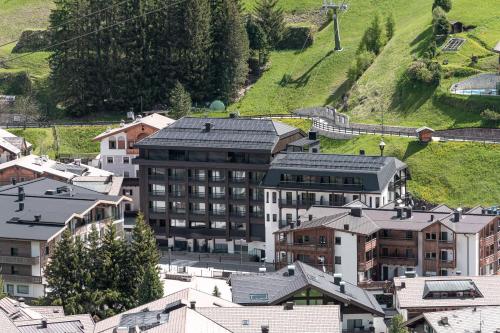 an overhead view of a city with a train in the distance at Stella Hotel - My Dolomites Experience in Selva di Val Gardena