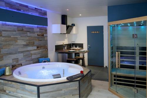 a large bathroom with a tub and a shower at Bulles Emotions in Arbois