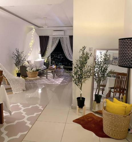 a living room with a couch and a table at Blubelle Apt Near Lake Garden Zoo With Wifi Netflix in Taiping