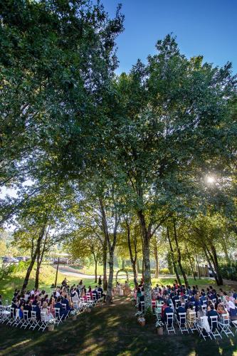 a crowd of people sitting in chairs under trees at Quinta Das Essências in Penafiel