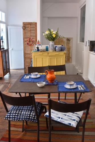 - une table avec deux chaises et un pichet d'orange dans l'établissement La Maison d'Elysa, à Perpignan