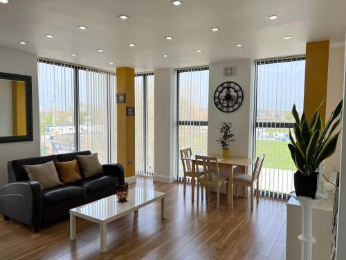 a living room with a couch and a table at Castle Quarter - Free Parking - Fast Fibre in Bedford
