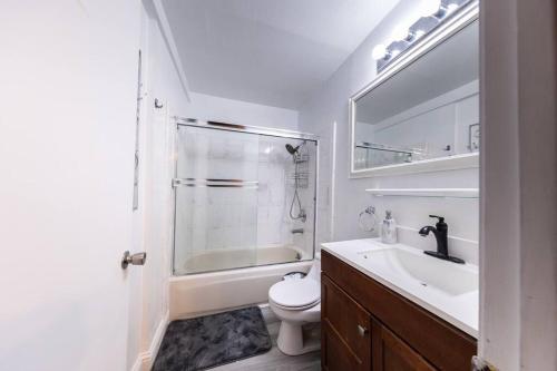 a bathroom with a sink and a toilet and a shower at Quiet Home Near SFO with Backyard / BBQ in San Bruno