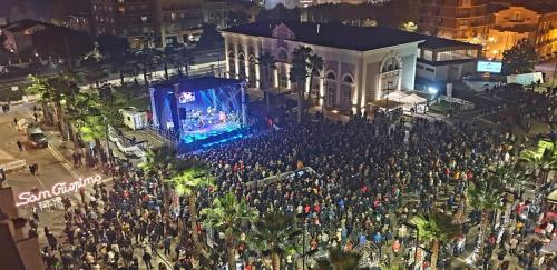 a large crowd of people on a city street at night at Meraki in Porto SantʼElpidio