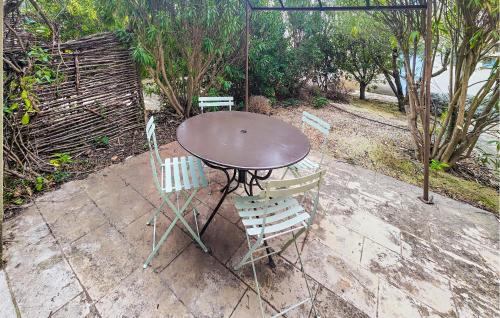 une table avec deux chaises et une table avec un parasol dans l'établissement Lovely Home In Saint-Laurent-De-La-Ca, à Saint-Laurent-de-la-Cabrerisse