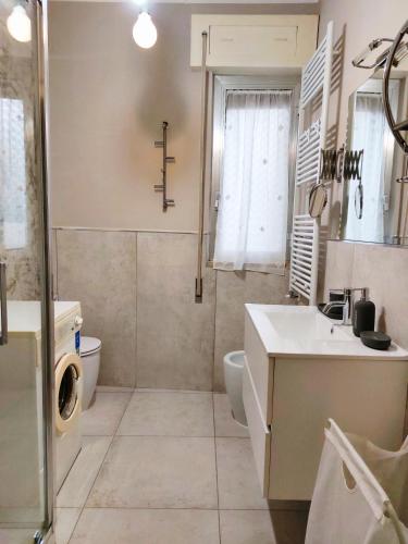 a bathroom with a sink and a toilet and a shower at La casetta di Rosa - Lentella in Lentella
