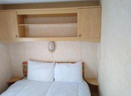 Tempat tidur dalam kamar di Caravan Holidays at Sand le mere