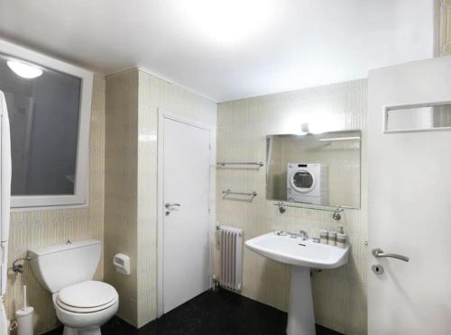 a bathroom with a white toilet and a sink at Hestia Anemone - Spacious Apartment in Kolonaki in Athens