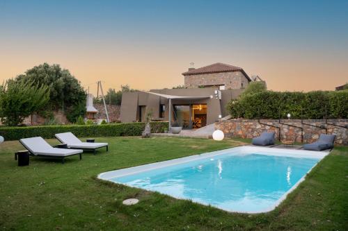a backyard with a swimming pool and a house at LITHARI Luxury Villa with Private Pool, Your Perfect Retreat, Crete in Agios Nikolaos