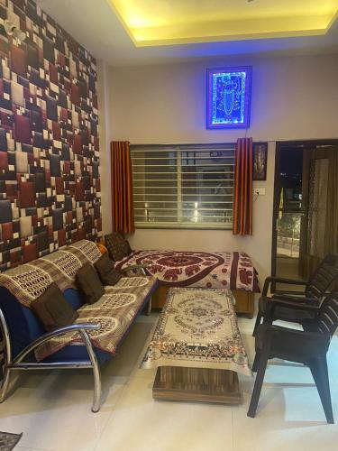 a living room with several beds and a window at Badal Home Stay Indore Near IIM Indore, RRCAT and IPS, Medicap in Indore