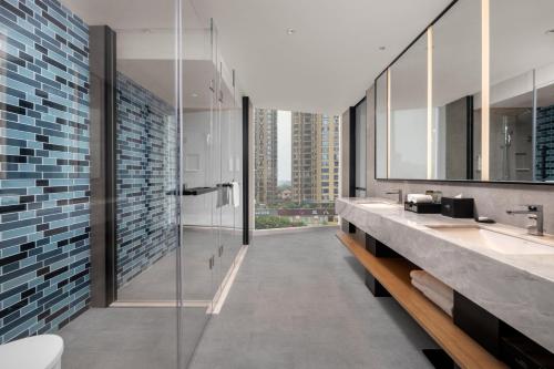 a bathroom with two sinks and a shower at Fairfield by Marriott Changsha Yuelu in Changsha