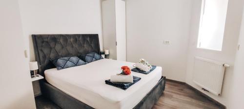 a bedroom with a large bed with a black headboard at Apartment Kino in Ljubljana
