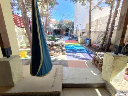 a closed umbrella sitting on the side of a building at Chania Hostel Youth in Chania Town