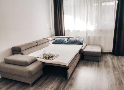 a bed and a couch in a room at Apartment Kino in Ljubljana