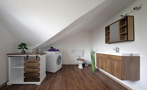 a bathroom with a sink and a washing machine at Ferienwohnung am Schwimmteich 2 in Lachendorf