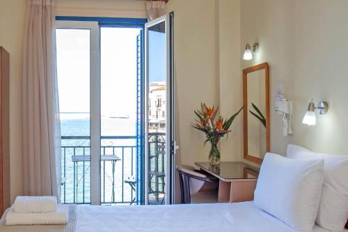 a hotel room with a bed and a balcony at Lucia Hotel in Chania Town